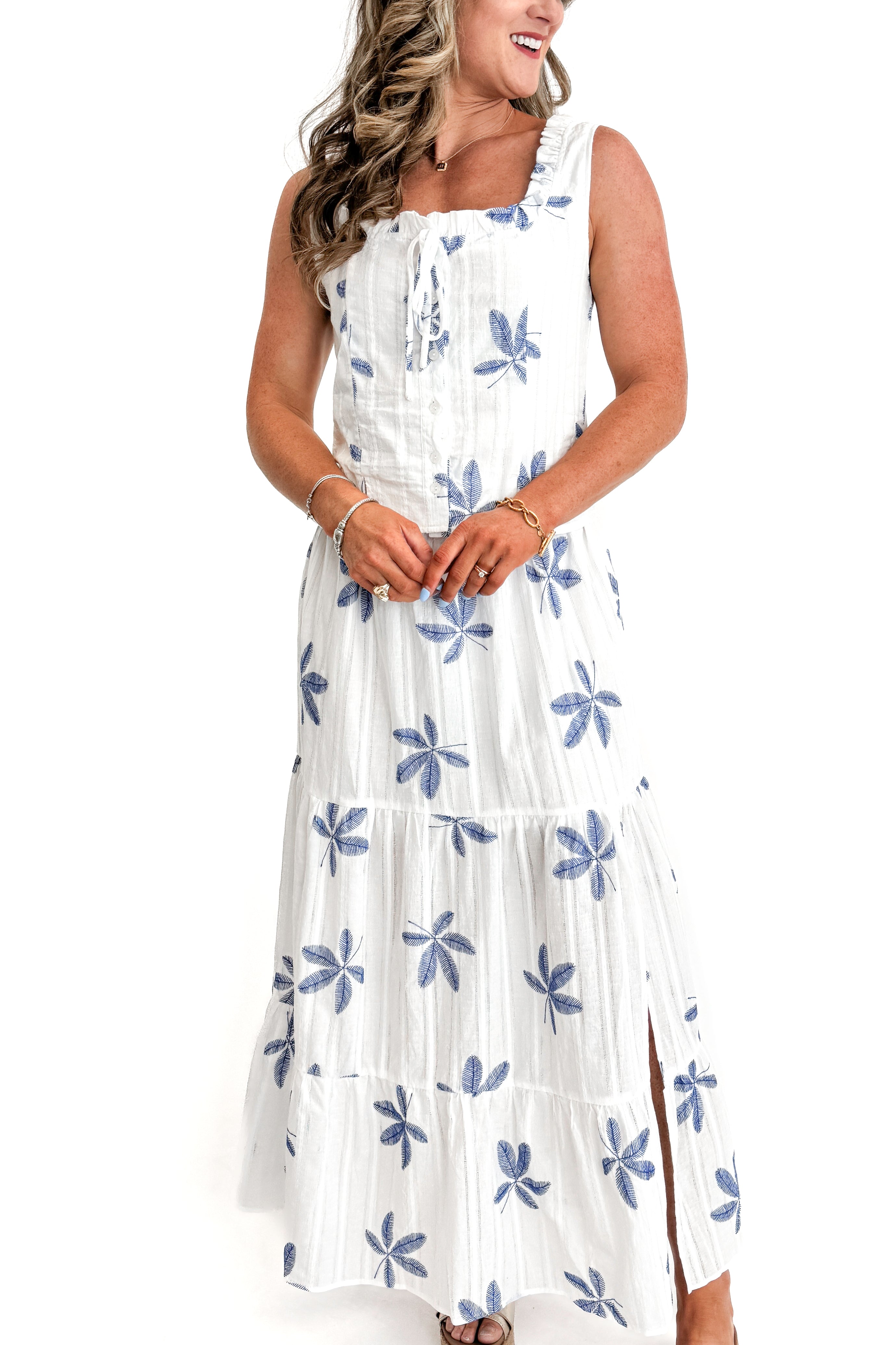 Front view of woman wearing White With Blue Embroidery Top with matching skirt against white studio background.