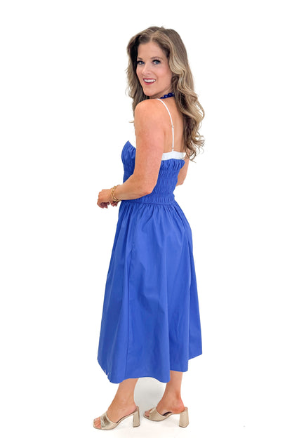Side view of woman wearing Blue With White Color Block Smocked Midi Dress against white studio background.