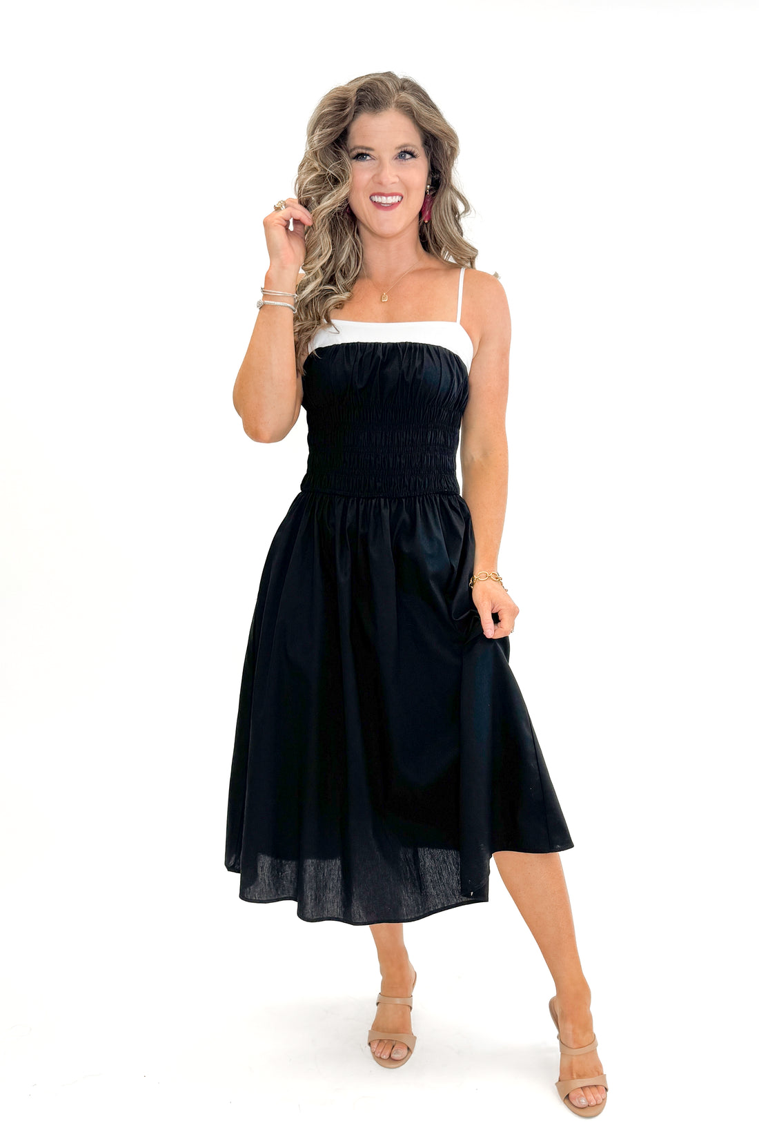 Front view of woman wearing Black With White Color Block Smocked Midi Dress against white studio background.
