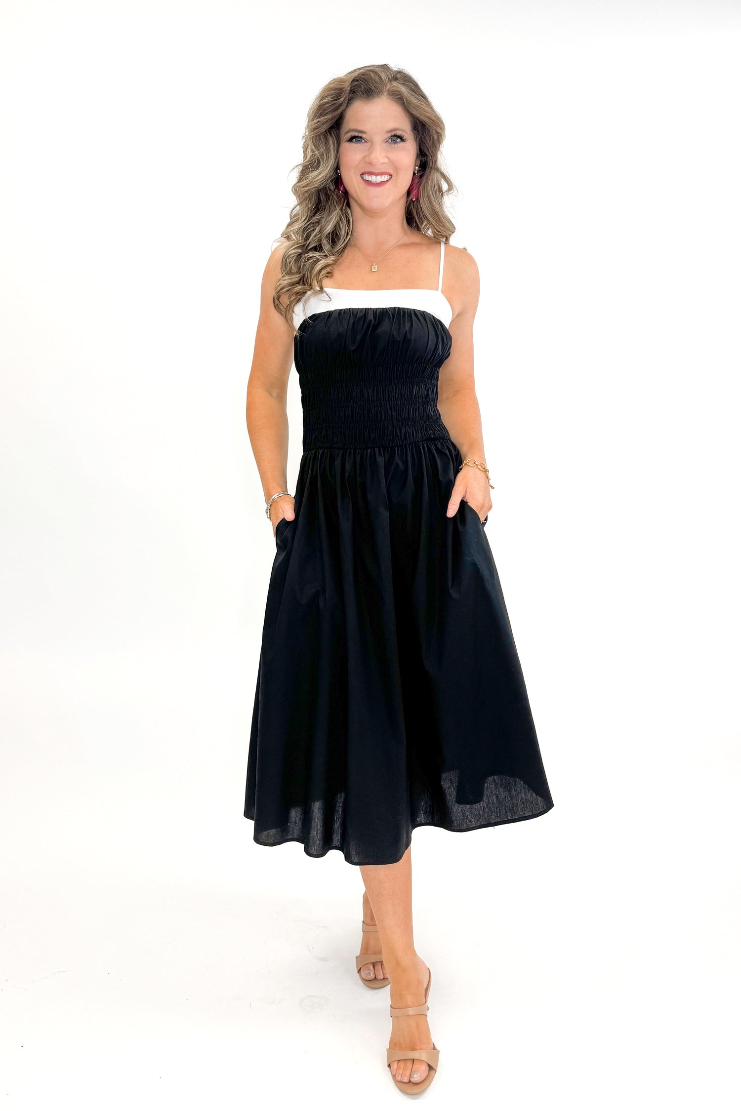 Front view of woman wearing Black With White Color Block Smocked Midi Dress against white studio background.