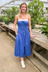 Front view of woman wearing Blue With White Color Block Smocked Midi Dress at a garden center.