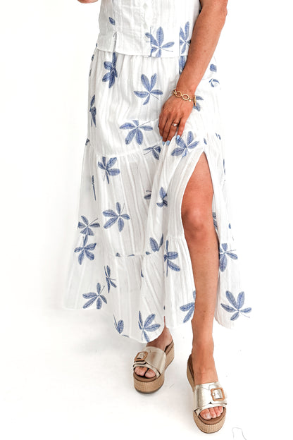 Front view of woman wearing White With Blue Embroidery Tiered Skirt with matching top against white studio background.