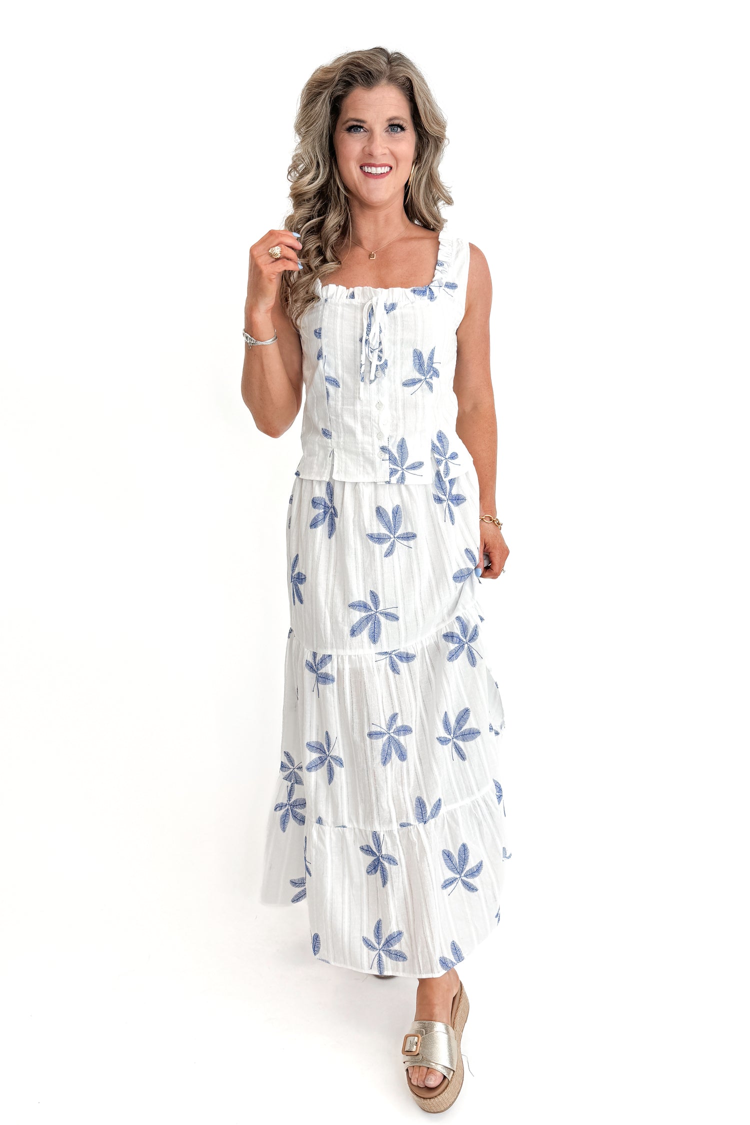Front view of woman wearing White With Blue Embroidery Tiered Skirt with matching top against white studio background.