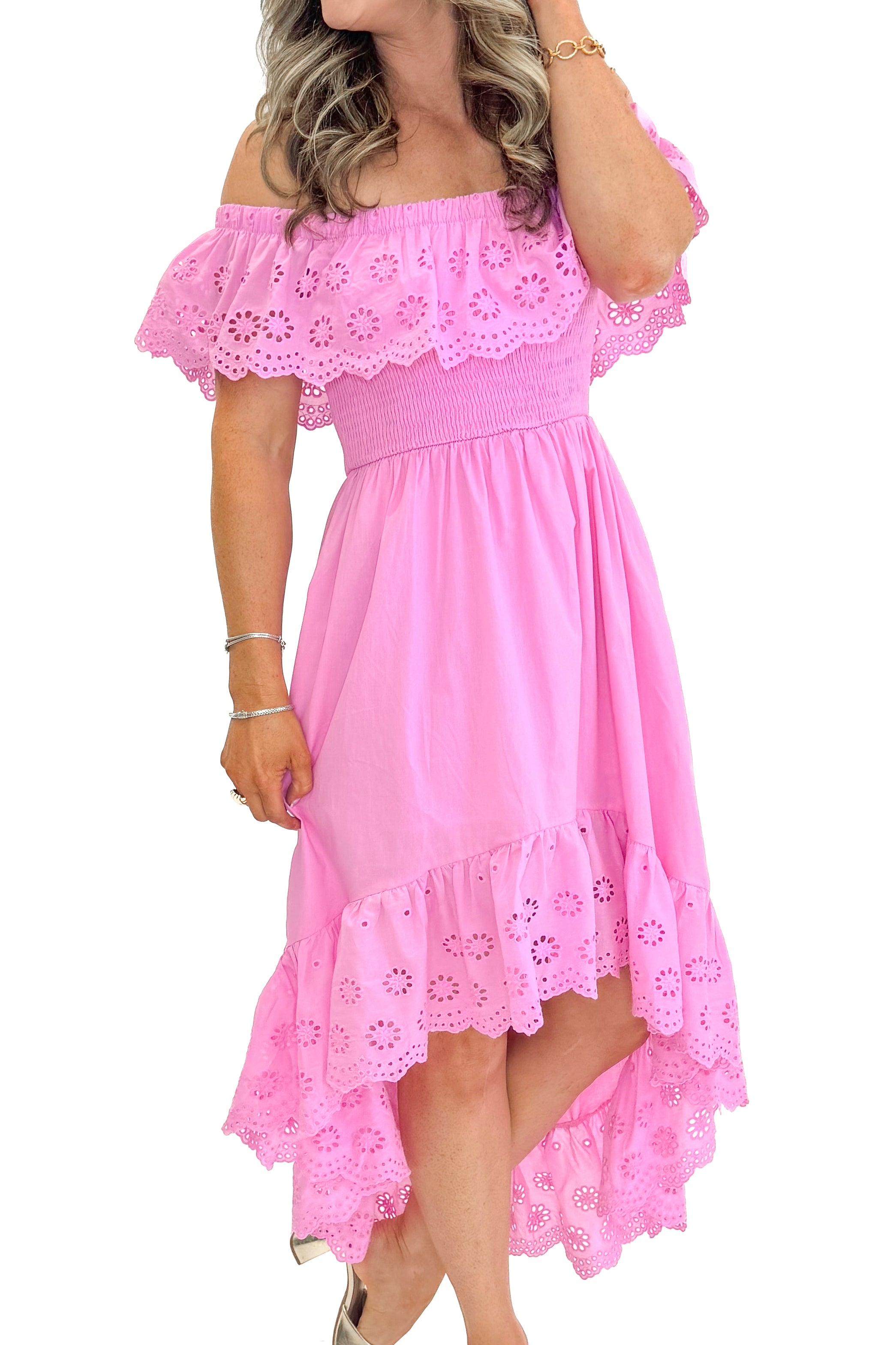 Side view of woman wearing Pink Eyelet Detail Hi-Low Dress against white studio background.
