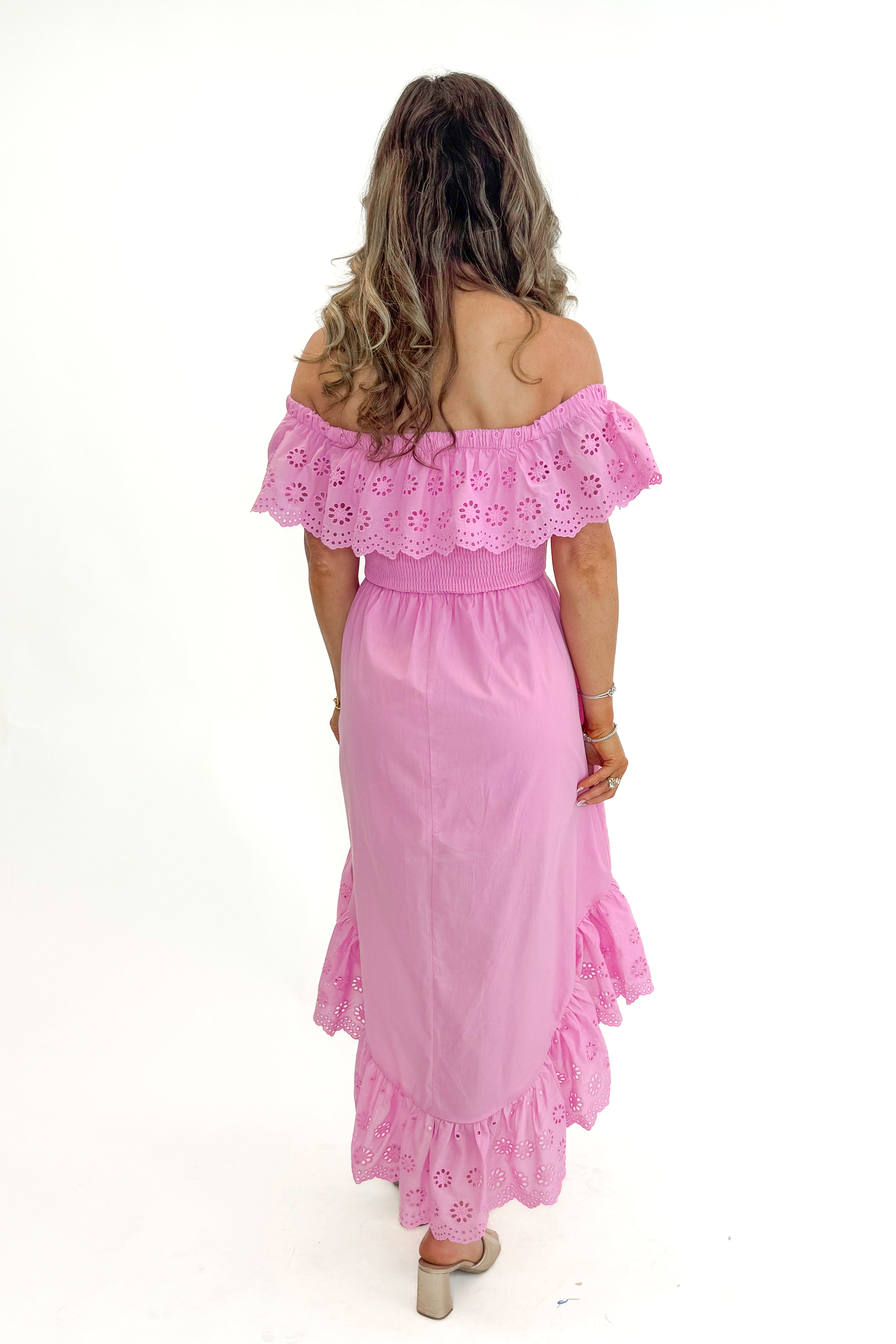 Back view of woman wearing Pink Eyelet Detail Hi-Low Dress against white studio background.