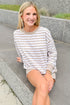 Front view of woman wearing Swagger Boutique’s Heather Ash The Everyday Striped Crew with Heather Ash The Everyday Short sitting outside at a park.