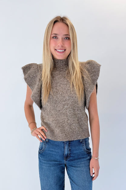 Front view of woman wearing Swagger Boutique’s Heathered Taupe Short Flutter Sleeve Sweater by Entro with jeans against white studio background.