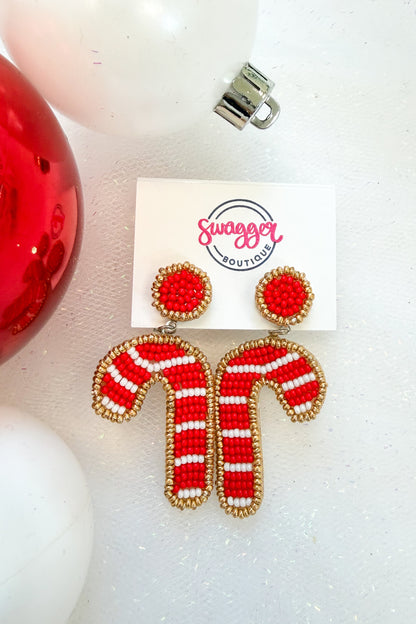 Holiday Spirit Earrings Candy Cane against holiday background.