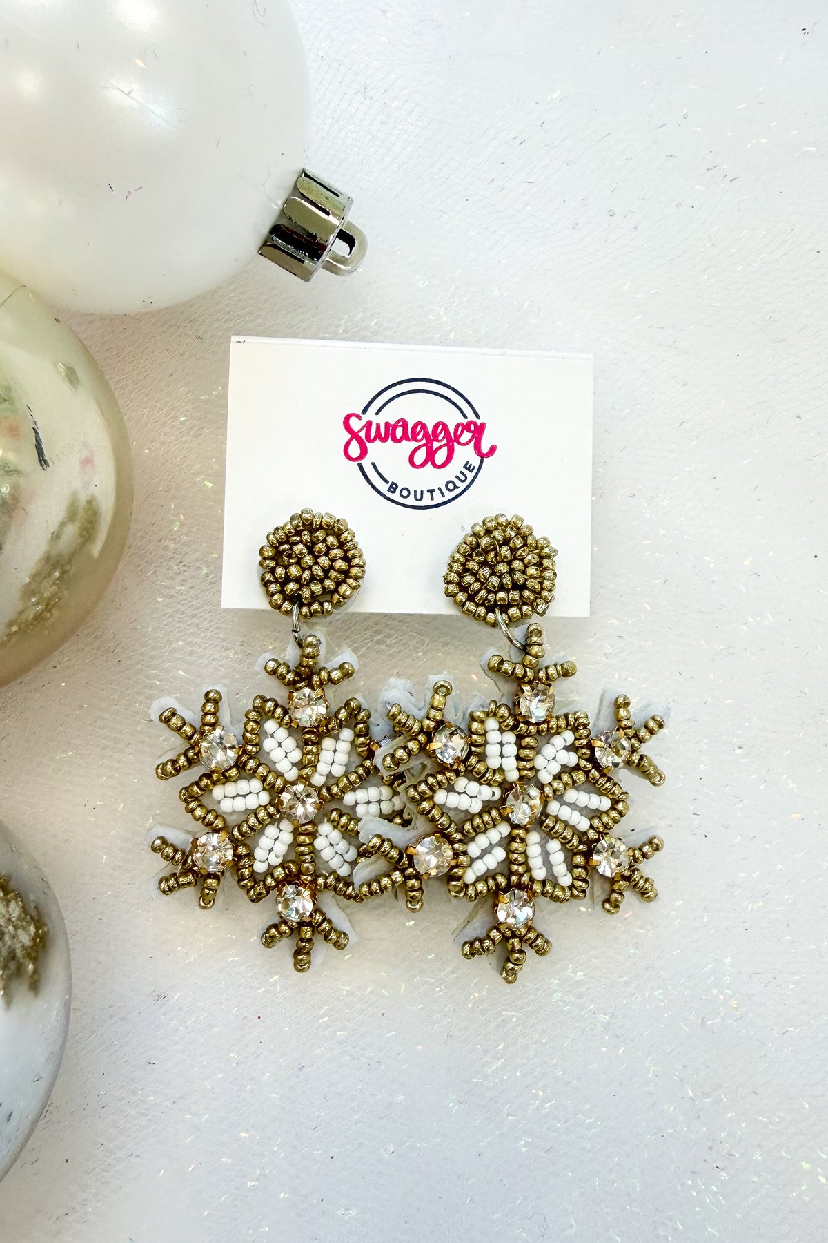 Holiday Spirit Earrings Snowflake against holiday background.