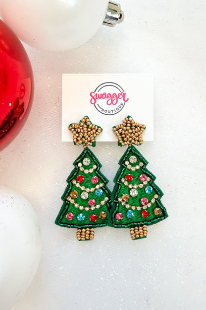 Holiday Spirit Earrings Christmas Tree against holiday background.