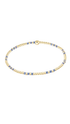 A delicate gold chain bracelet with alternating small blue and gold bead-like links, displayed on a clean white background.