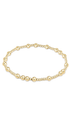 A delicate gold beaded bracelet with alternating large polished round beads and smaller textured beads, displayed on a clean white background.