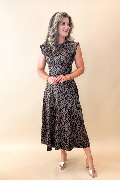 Front view of woman wearing Leopard Suede Midi Dress against tan studio background.