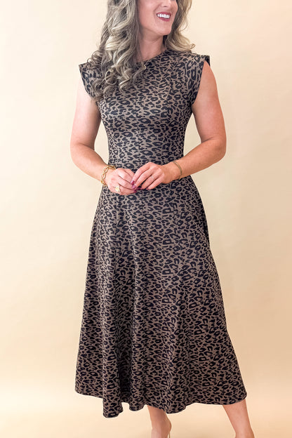 Front view of woman wearing Leopard Suede Midi Dress against tan studio background.
