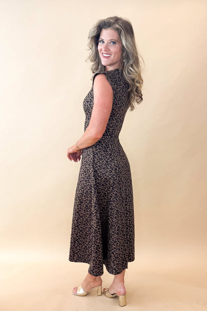 Side view of woman wearing Leopard Suede Midi Dress against tan studio background.