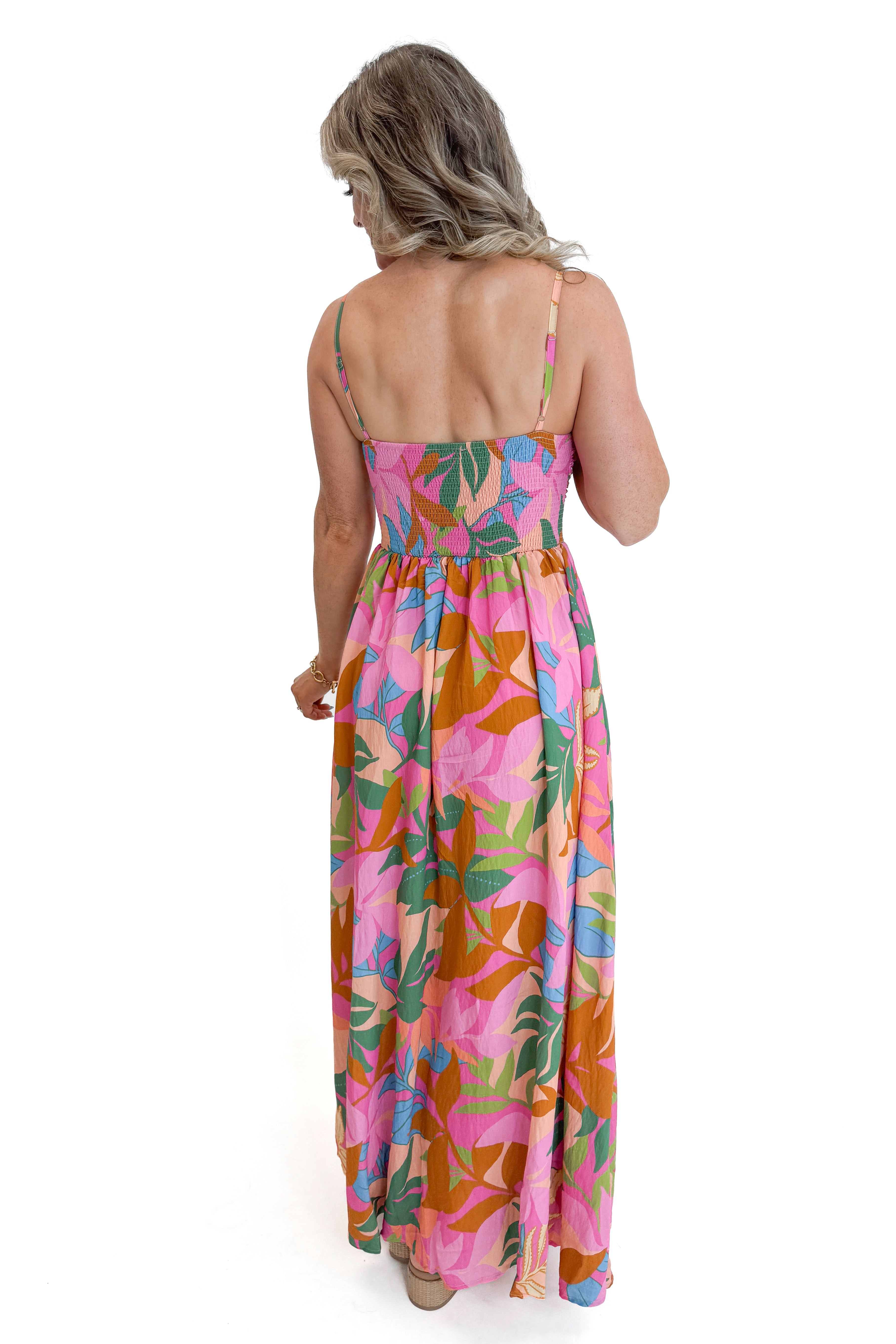 Back view of woman wearing Multi Tropical Printed Maxi Dress against white studio background.
