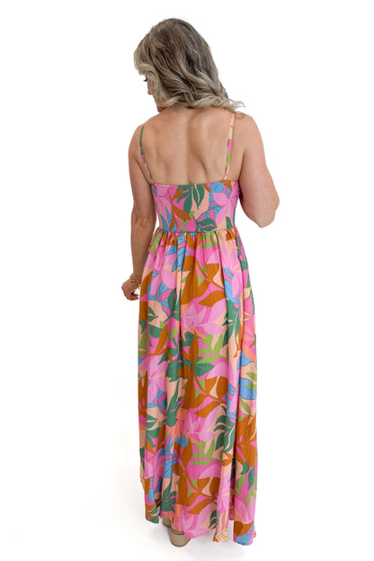 Back view of woman wearing Multi Tropical Printed Maxi Dress against white studio background.