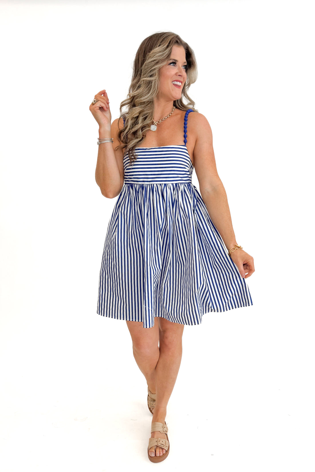 Front view of woman wearing Blue &amp; White Striped Bead Strap Dress with sandals against white studio background.
