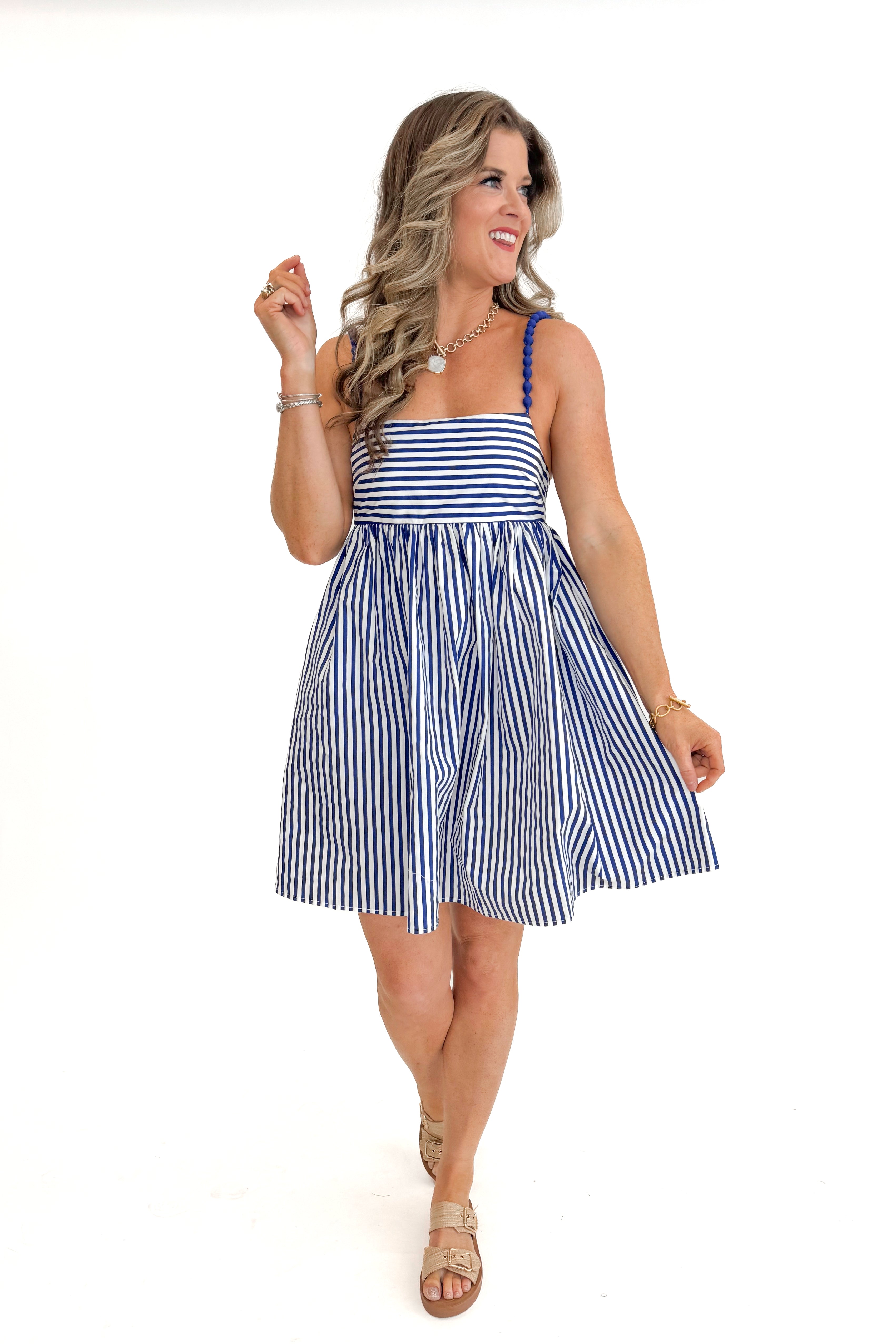 Front view of woman wearing Blue &amp; White Striped Bead Strap Dress with sandals against white studio background.