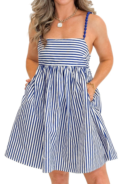 Front detail view of woman wearing Blue &amp; White Striped Bead Strap Dress with sandals against white studio background.