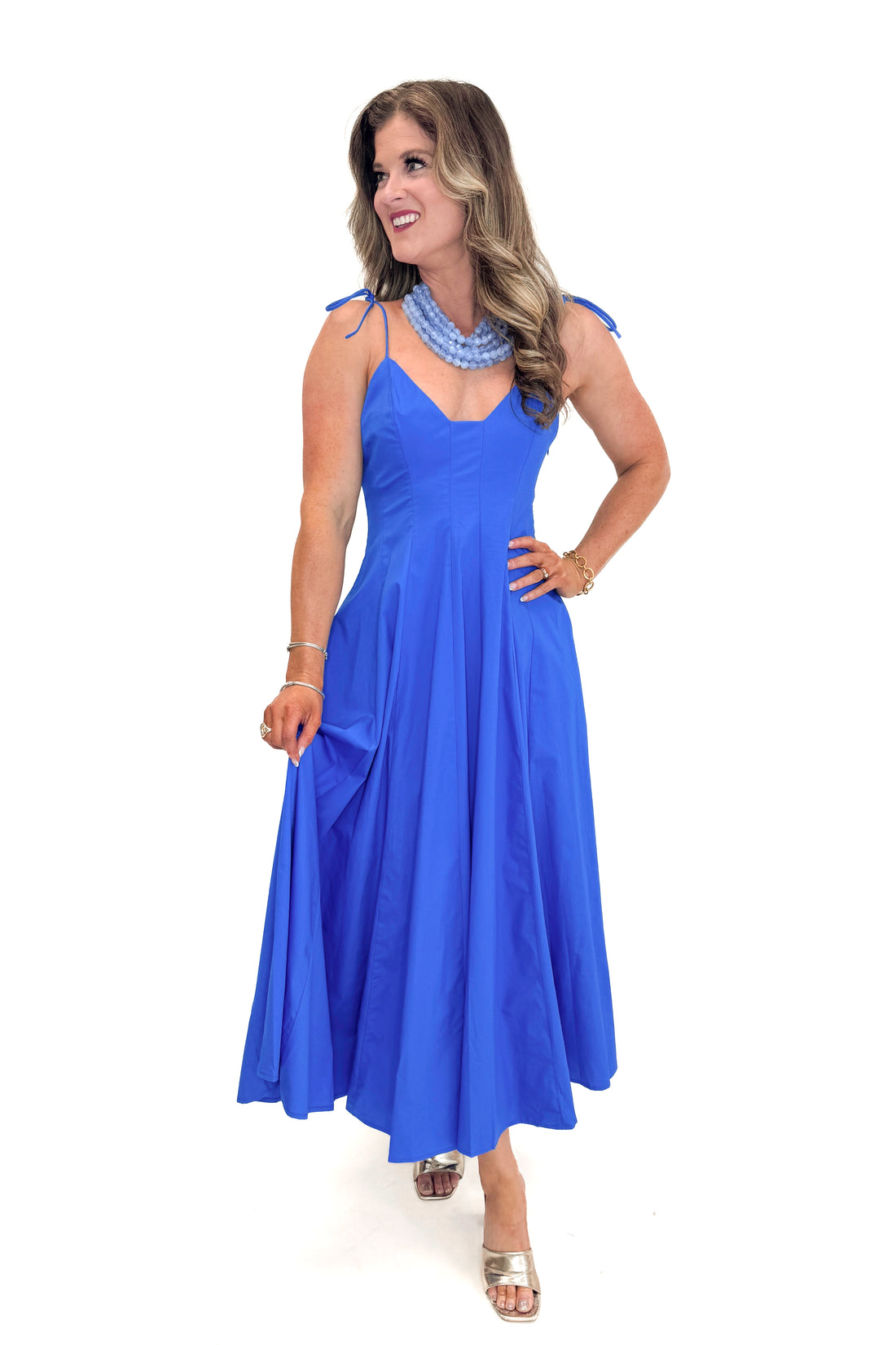 Front view of woman wearing Blue Tie Strap Maxi Dress against white studio background.