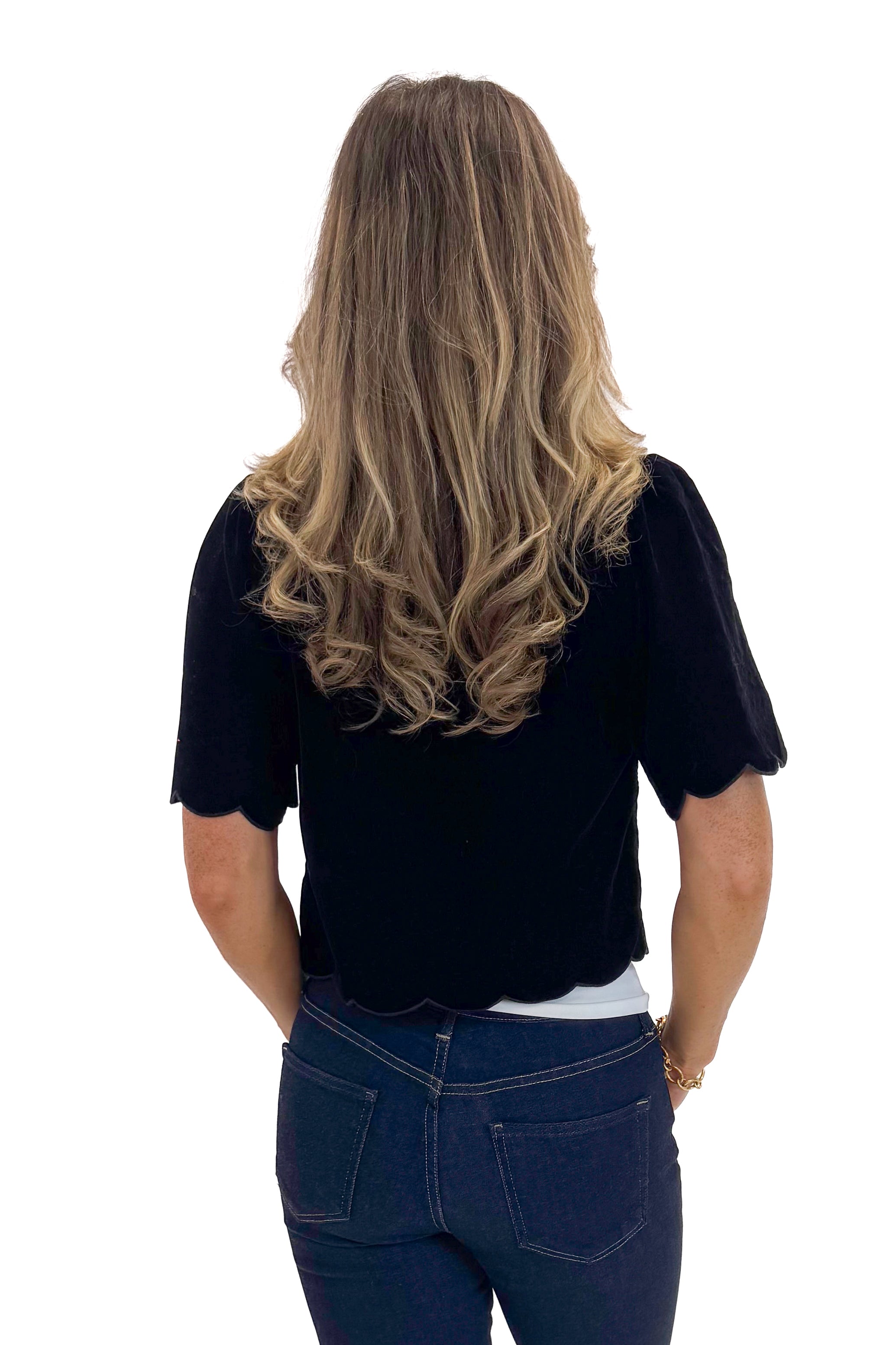 Back view of woman wearing Black Velvet Tie Front Top with jeans against white studio background.