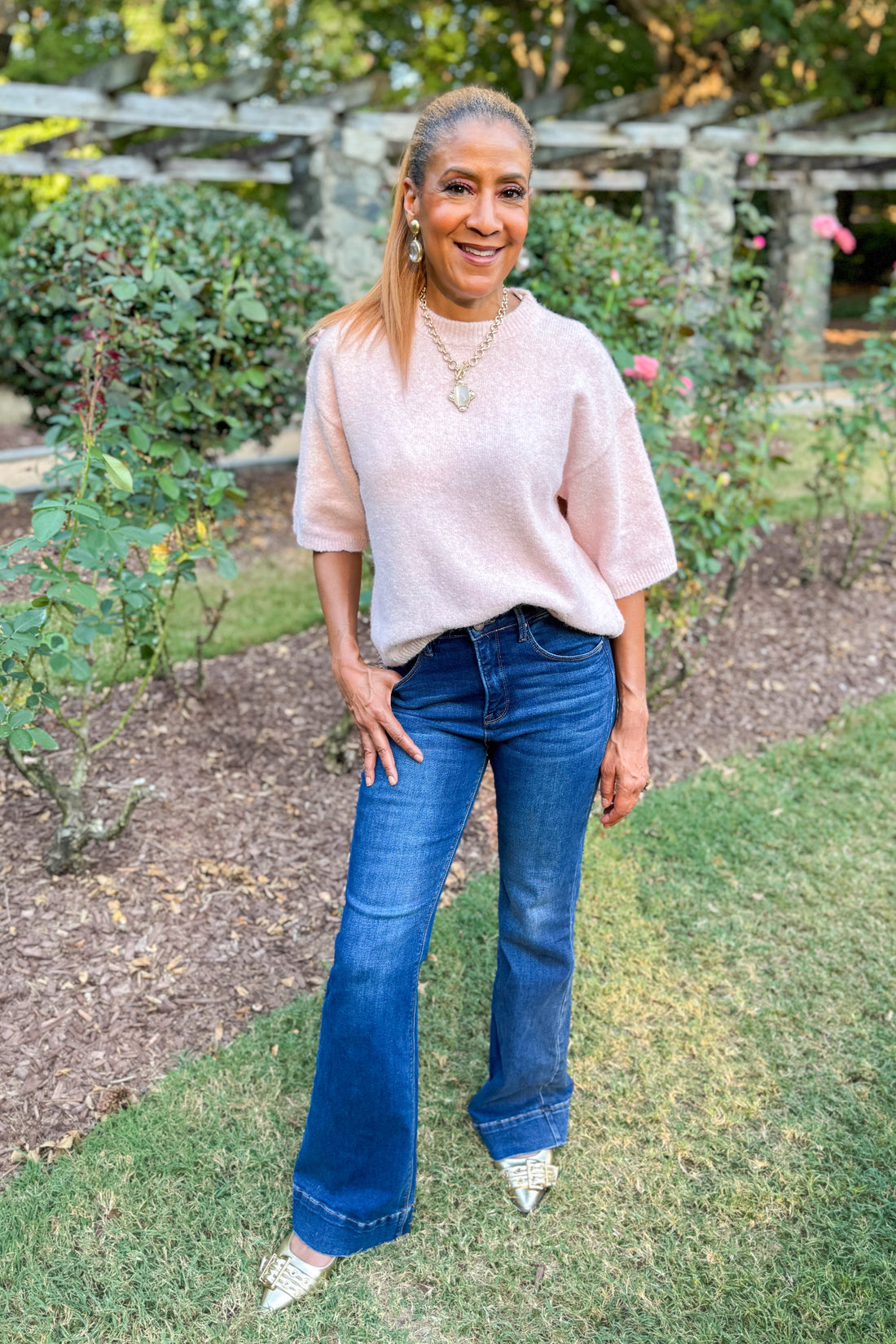 All The Rage light pink short sleeve sweater - full length model shot outside 