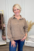 Woman wearing Mocha Chenille Collared Top and jeans with decor in the background.
