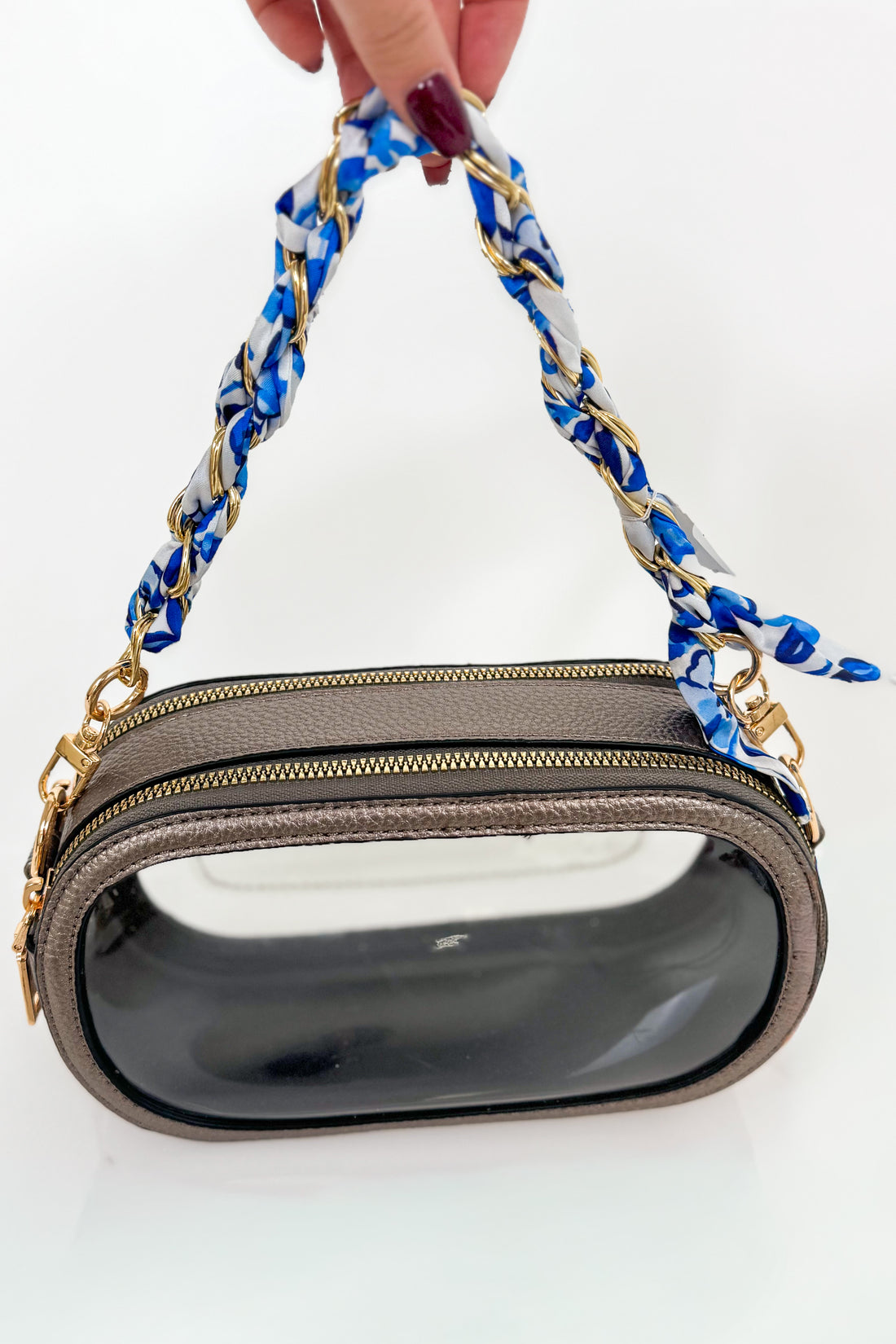Handbag with a blue and white patterned handle on a white background