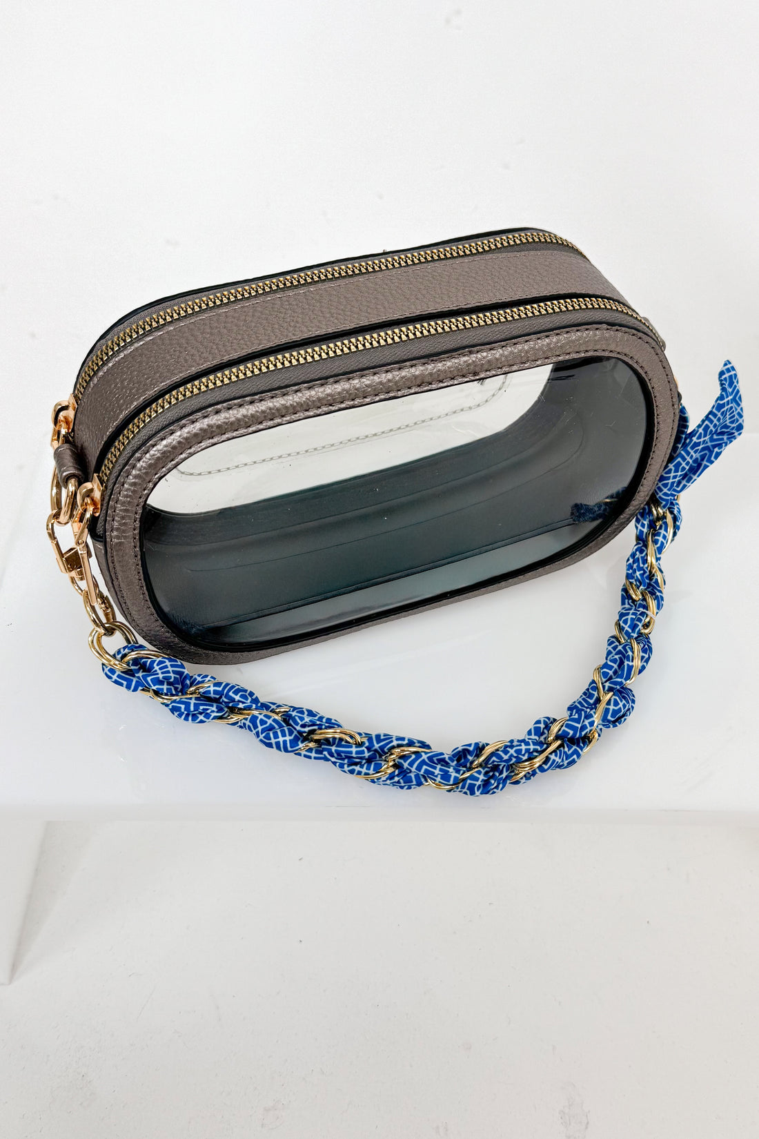 Small pouch with a blue braided strap on a white background