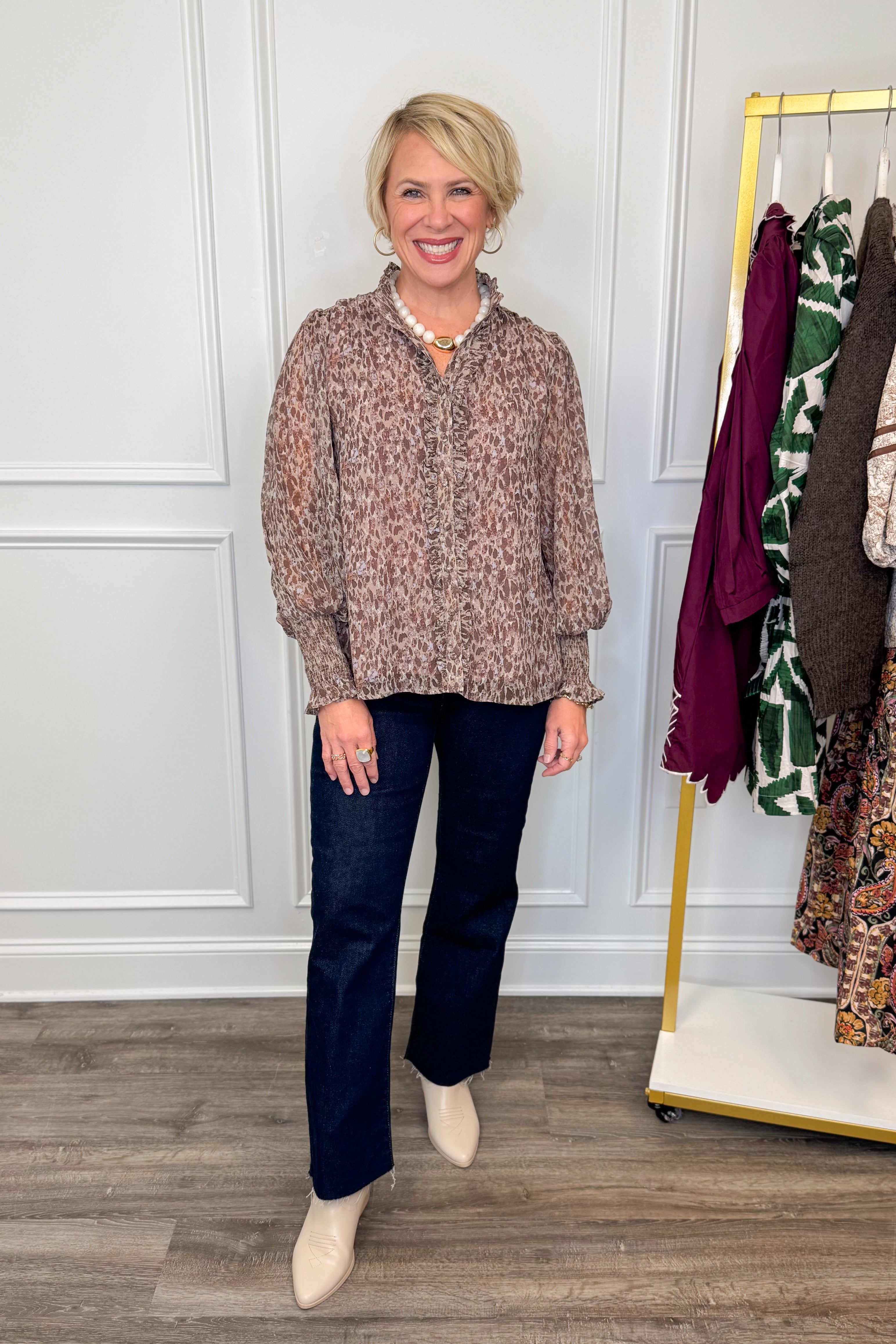 woman wearing printed long sleeve shirt with ruffle detailing