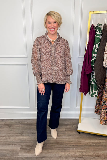 woman wearing printed long sleeve shirt with ruffle detailing