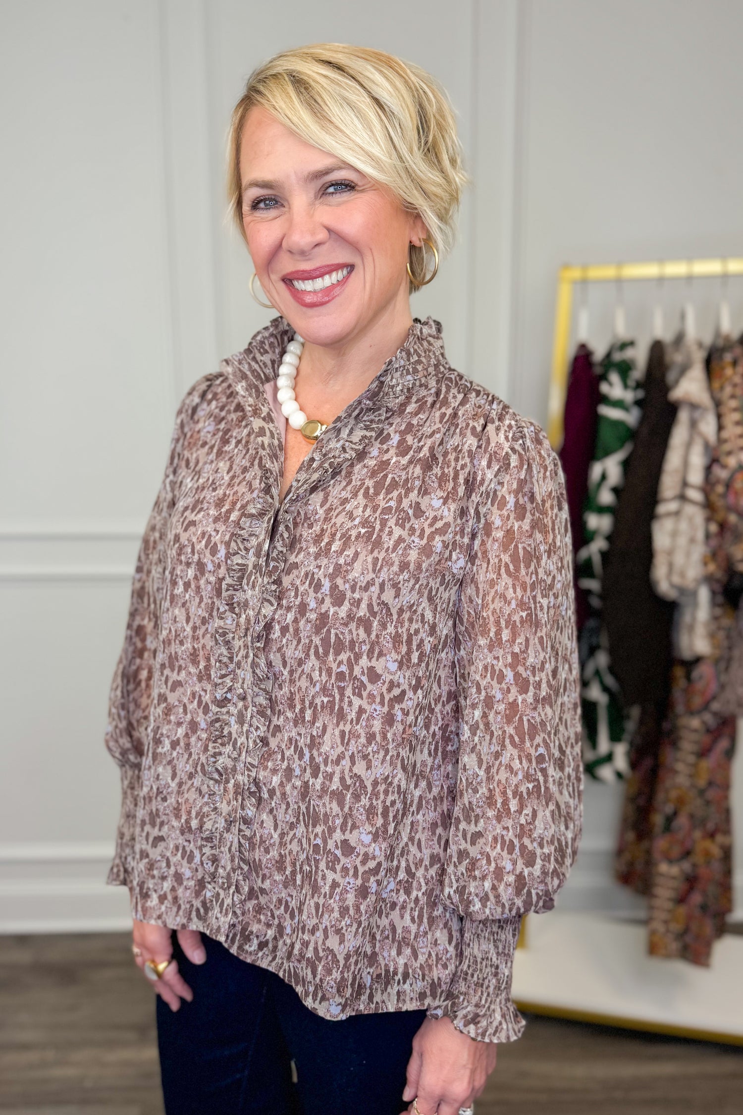 woman wearing printed long sleeve shirt with ruffle detailing