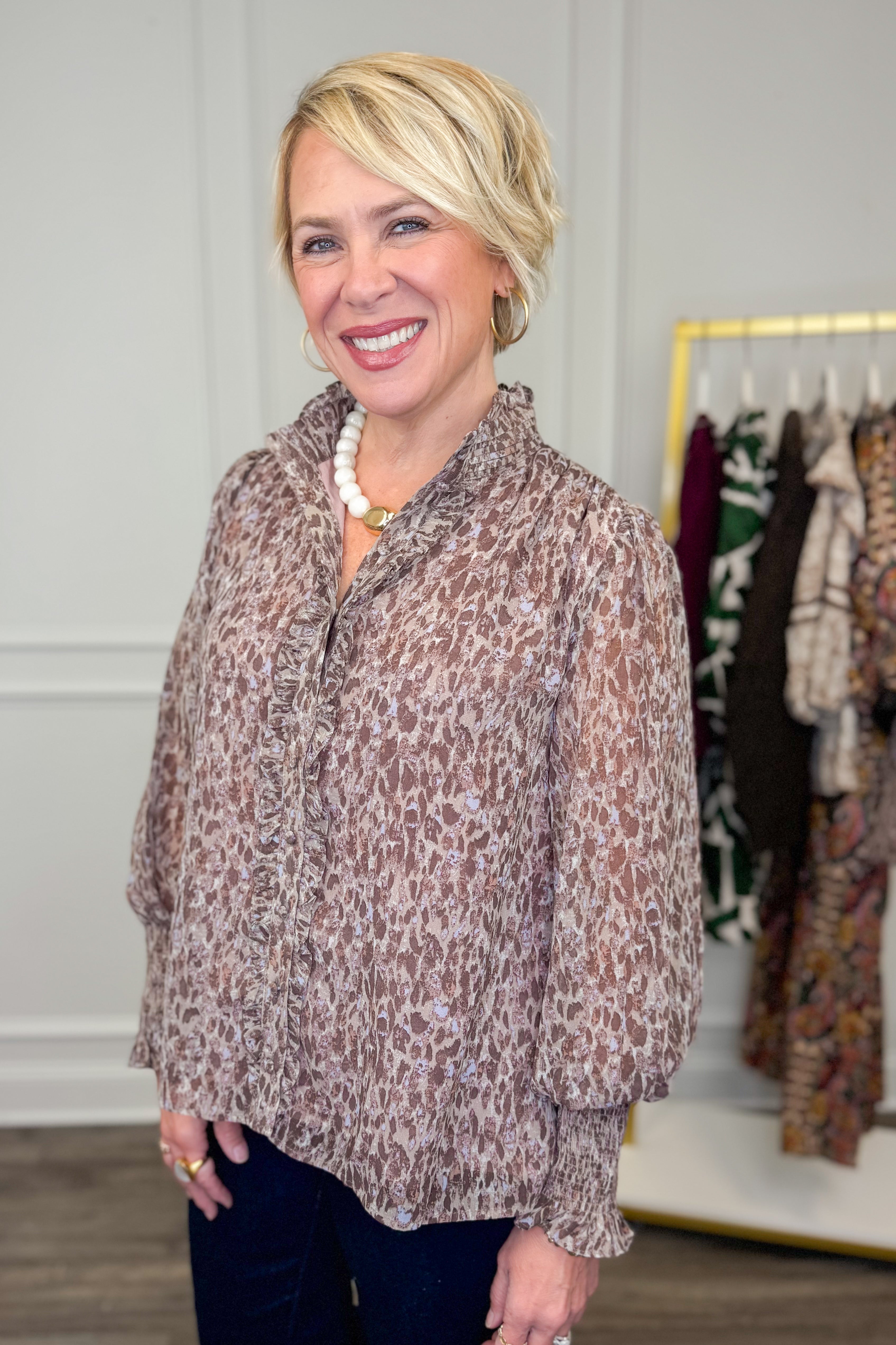 woman wearing printed long sleeve shirt with ruffle detailing