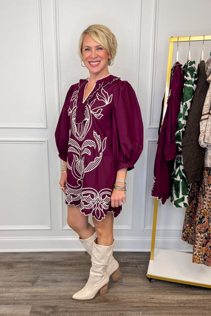 woman wearing burgundy embroidered dress 