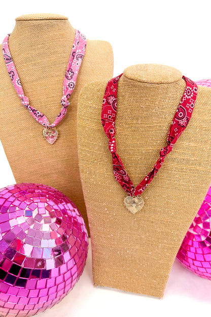 pink and red bandana scarf necklaces with heart pendants on each 
