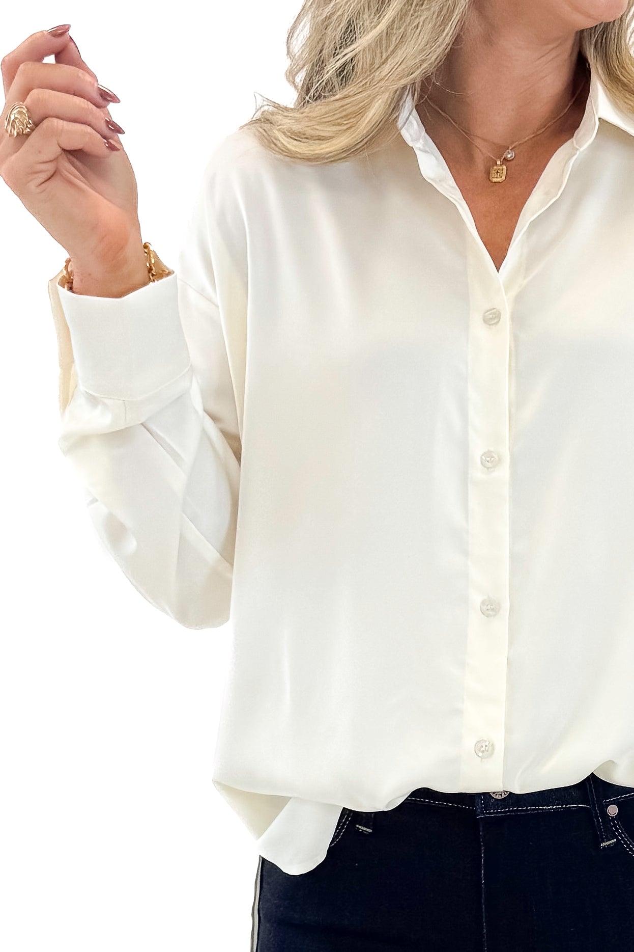 Front detail view of woman wearing Cream Oversized Satin Shirt with jeans against tan studio background.