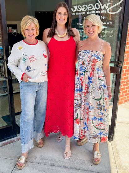 Front view of woman wearing Swagger Boutique’s Red Embroidered Maxi Dress with women wearing Multi Seas The Day Sienna Sweater by Z Supply and Multi Cornelia Getaway Dress by Z Supply standing outside.