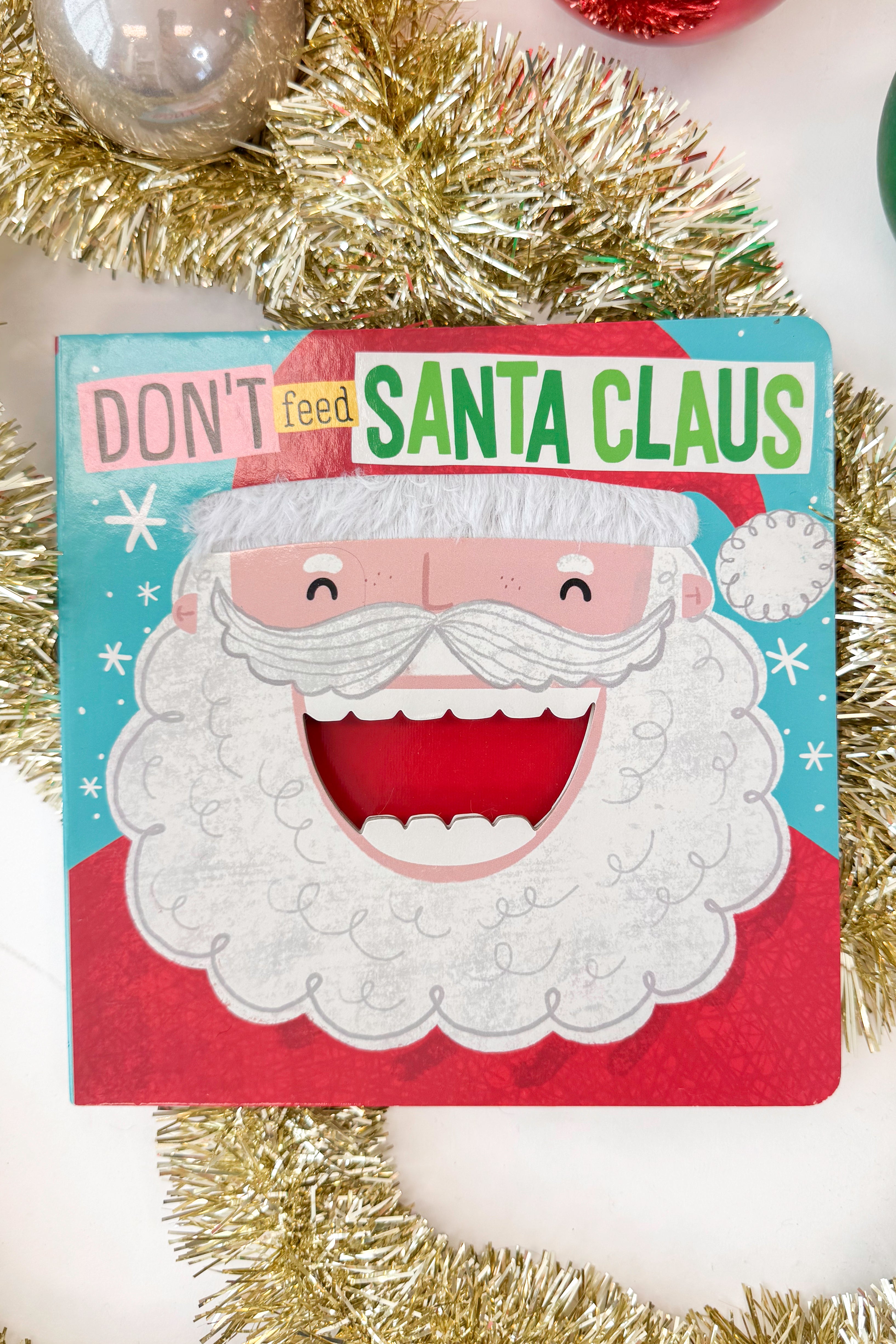 Book cover with a cartoon Santa Claus face and text &