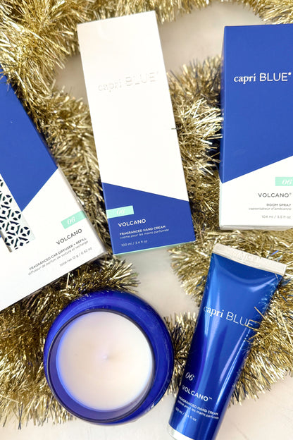 Capri products and Blue candle jar with silver lid on a white holiday background