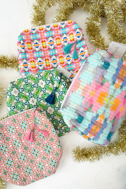 Collection of colorful fabric bags with tassels on a white background