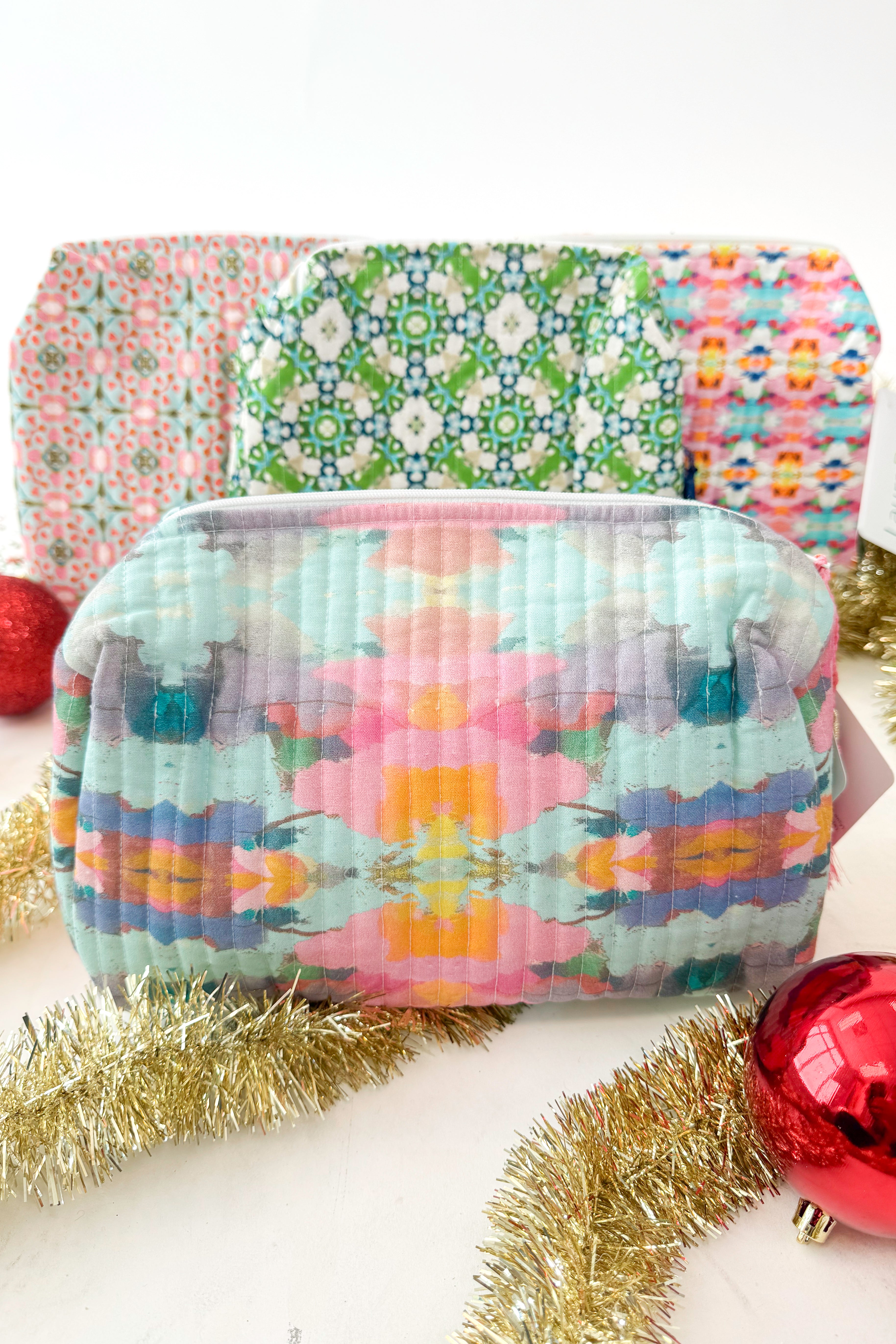 Collection of colorful fabric bags with tassels on a white background