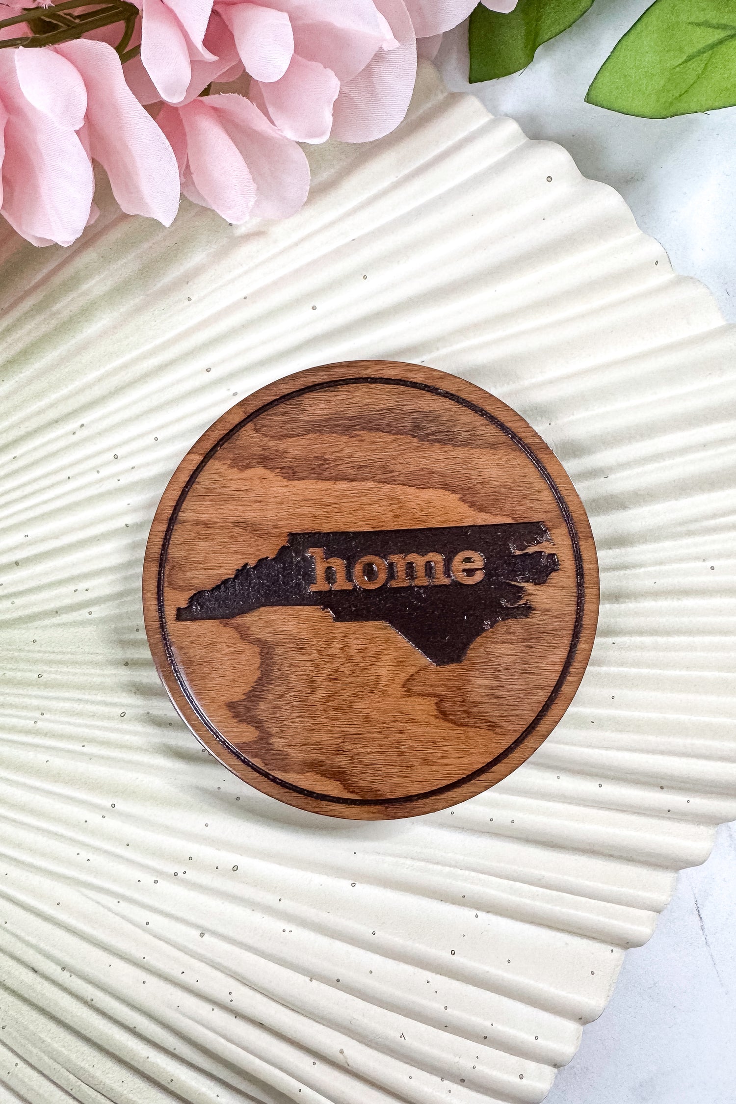 Wooden cutting board with a state outline and &