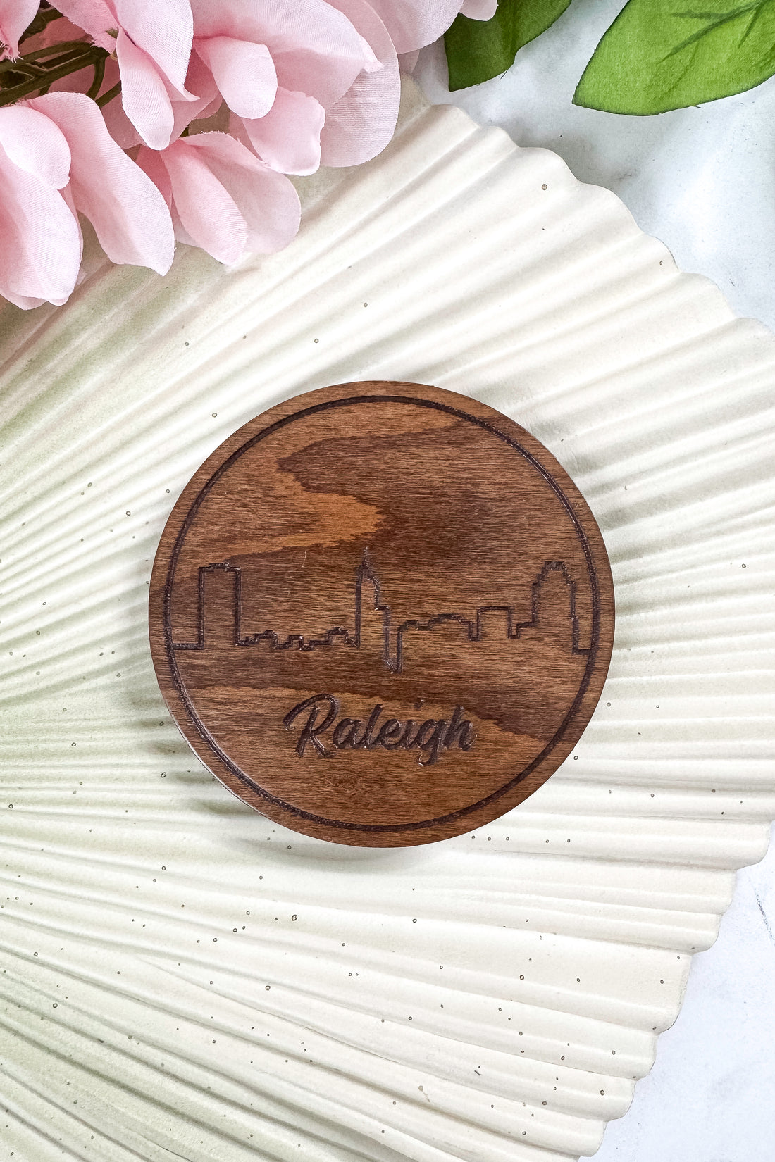 Wooden cutting board with a cityscape and &
