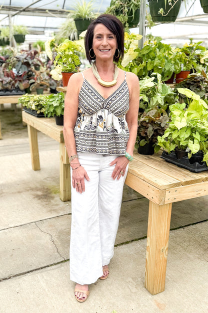Front view of woman wearing Black &amp; Multi Boho Printed V-neck Tank with jeans at a garden center