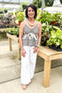 Front view of woman wearing Black & Multi Boho Printed V-neck Tank with jeans at a garden center