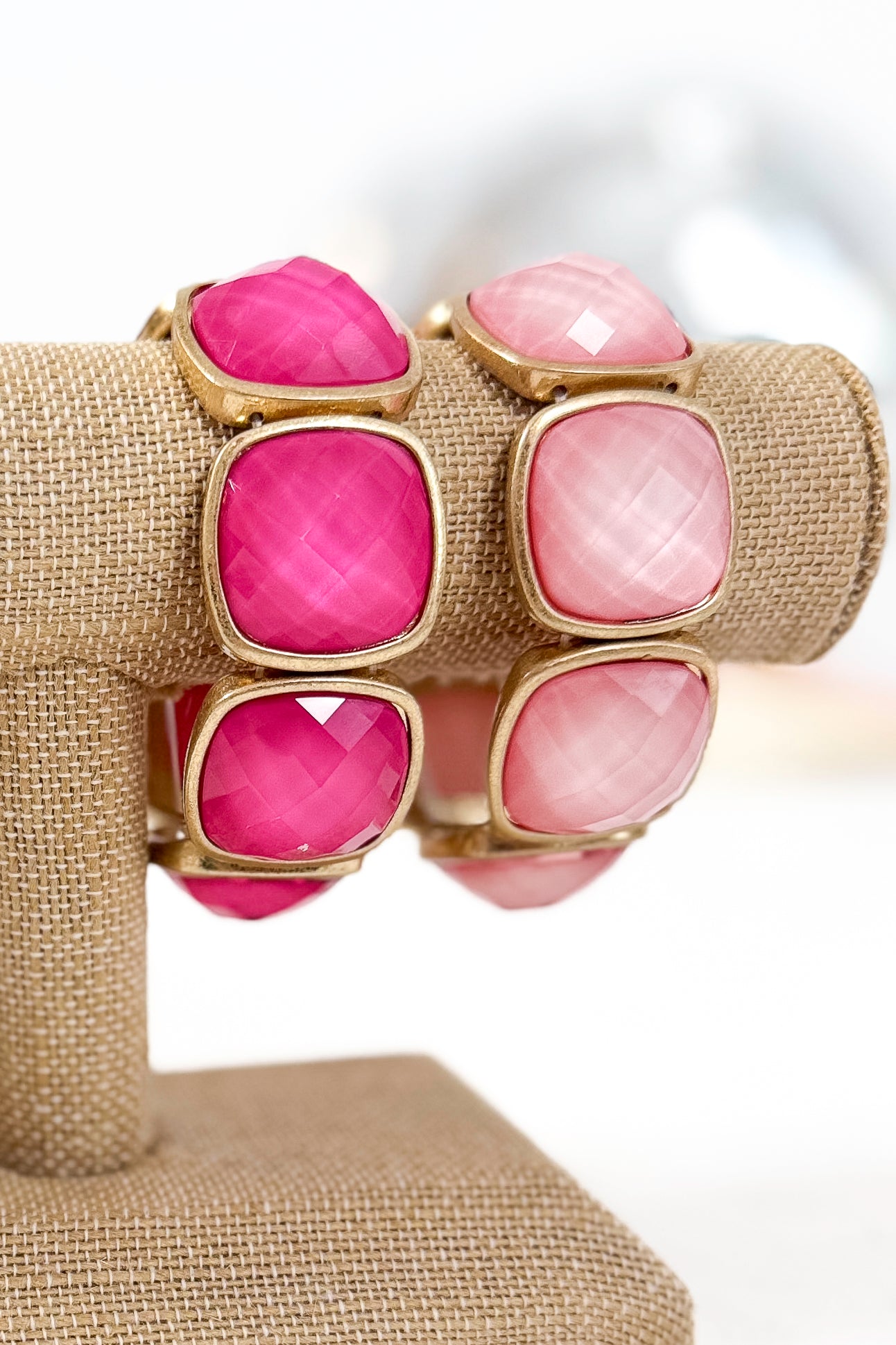 Colorful bracelets with gold accents on a white background