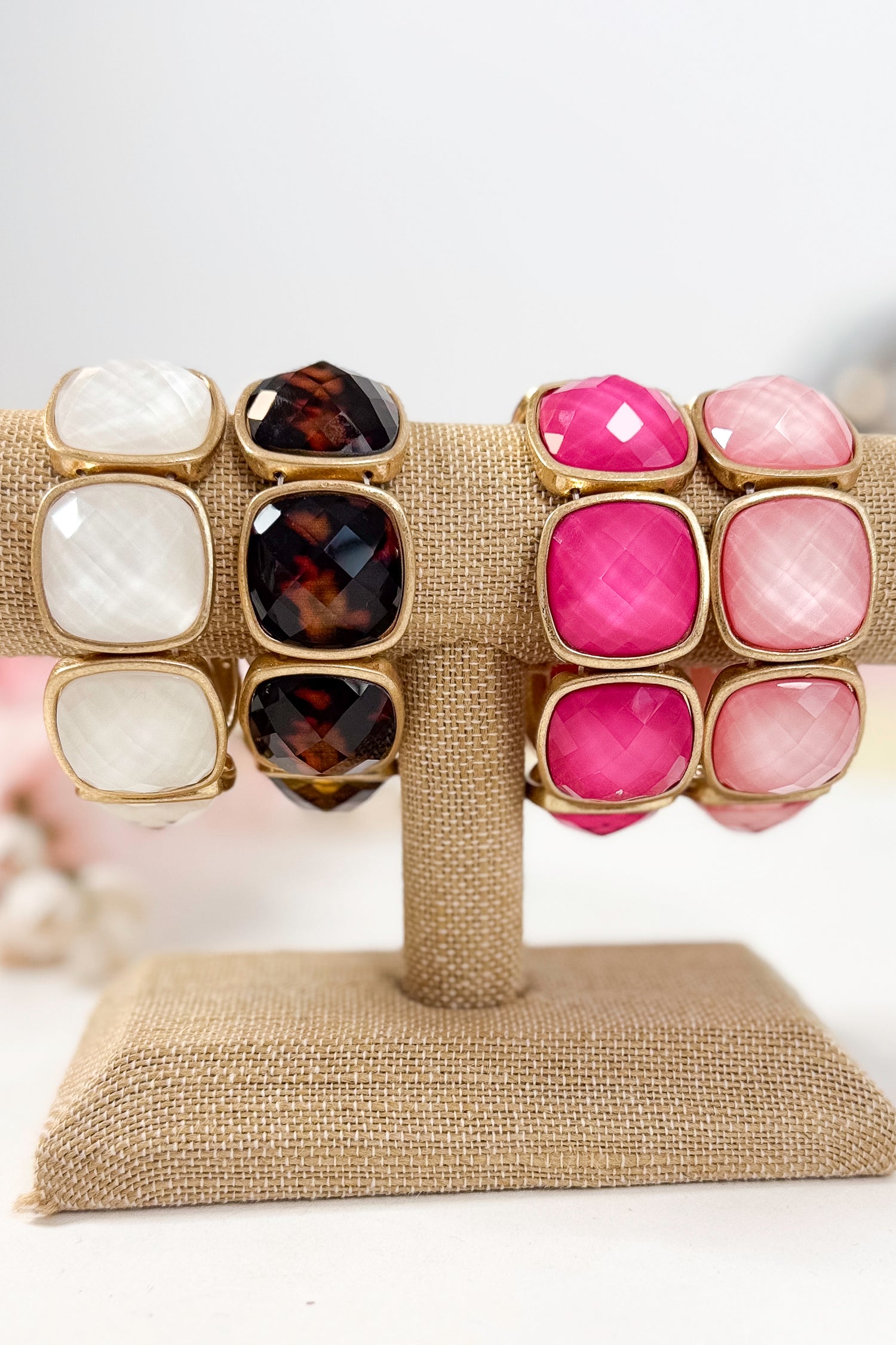 Colorful bracelets with gold accents on a white background