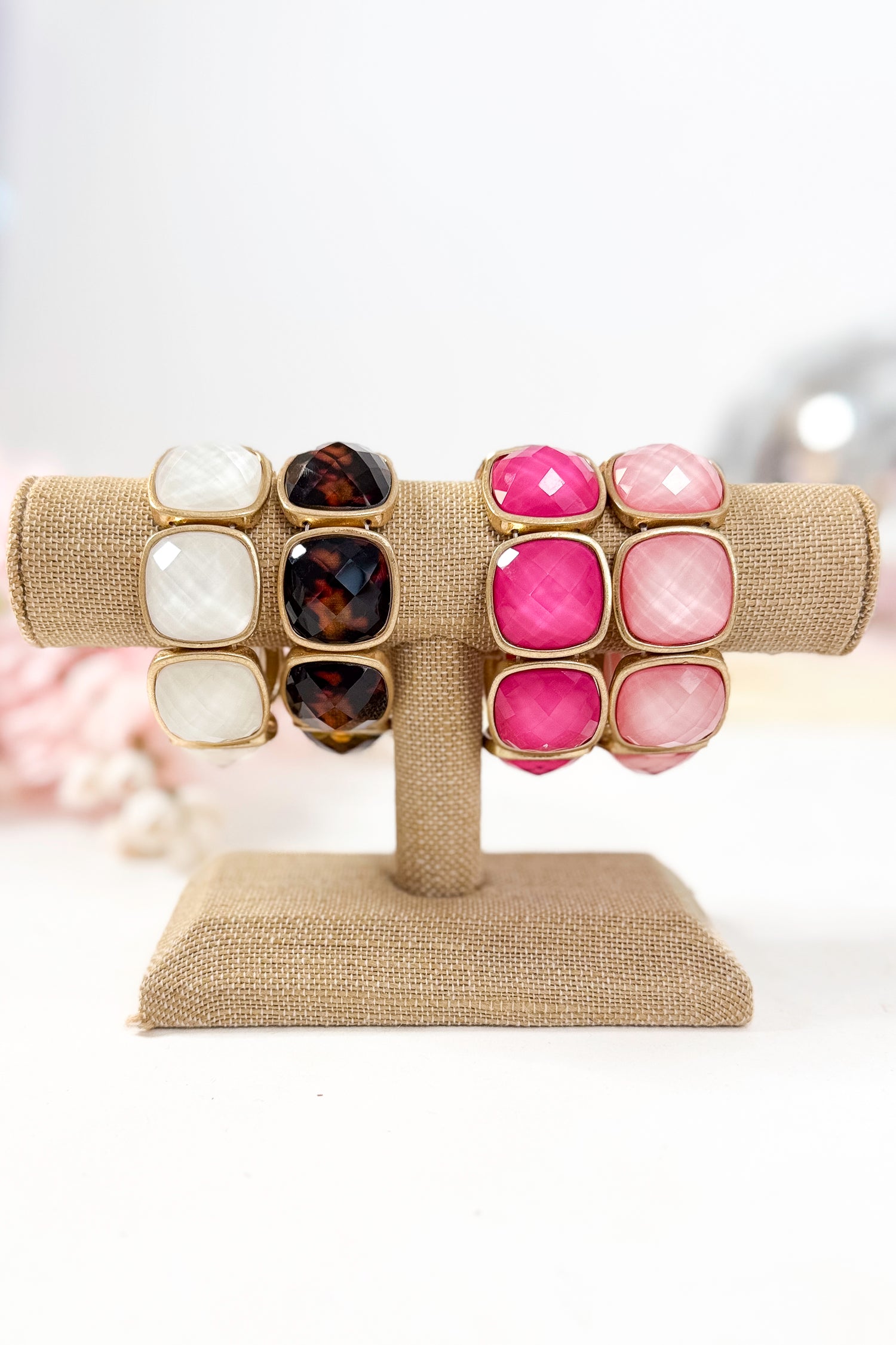Colorful bracelets with gold accents on a white background
