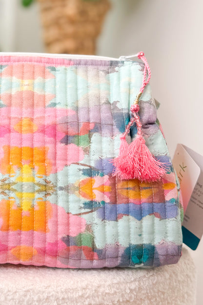 Multicolored textured pouch with a tassel on a light background